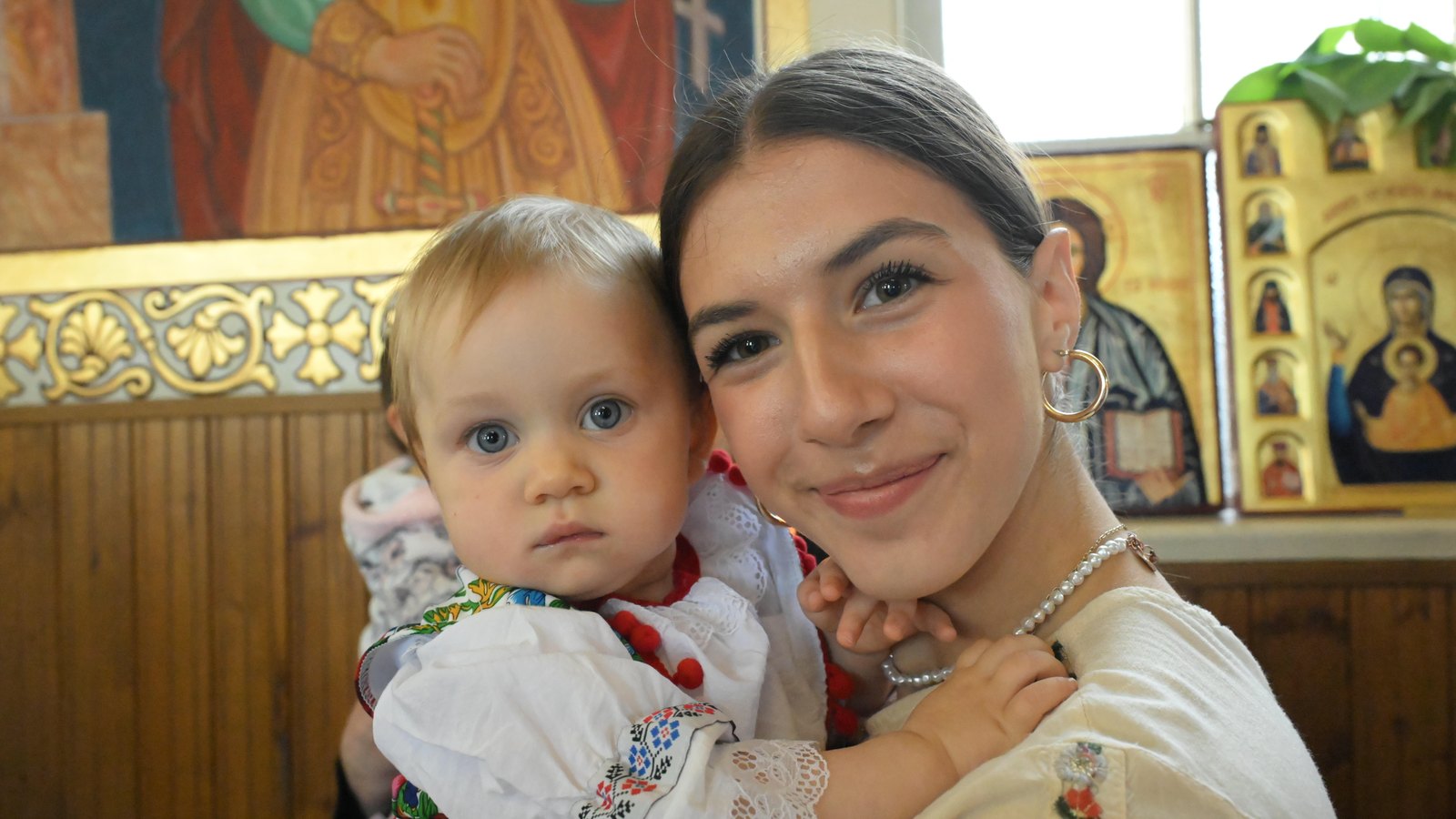 Family at Holy Trinity Romanian Orthodox Church during Hramul Bisericii