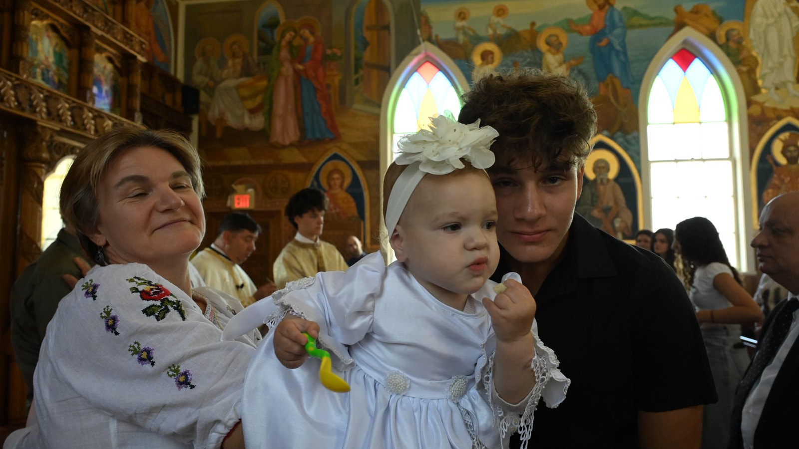 Child and family in Romanian dress during Hramul Bisericii